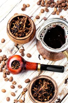 Stylish tobacco pipe with tobacco and brewed coffee