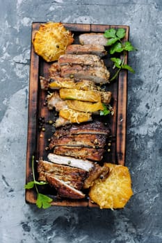 Juicy beef steak slices on wooden board