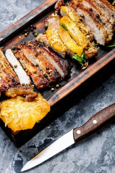 Grilled beef steak with pineapple on cutting board