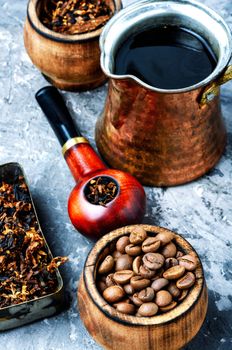 Stylish tobacco pipe with tobacco and brewed coffee