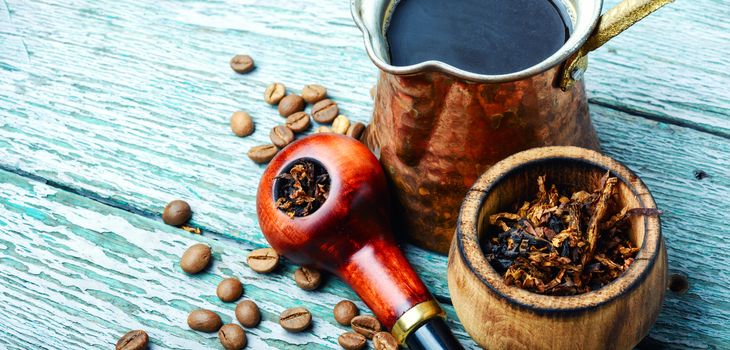 Stylish tobacco pipe with tobacco and brewed coffee