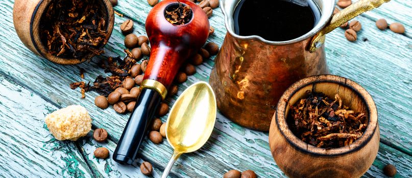 Stylish tobacco pipe with tobacco and brewed coffee