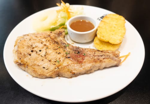 grilled steak with vegetables on white dish