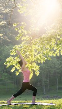 young beautiful asian woman practicing yoga  in the garden