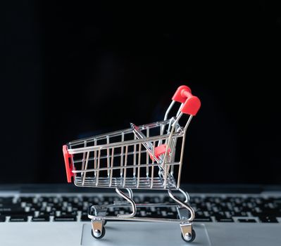 shopping cart on laptop, online shopping concept