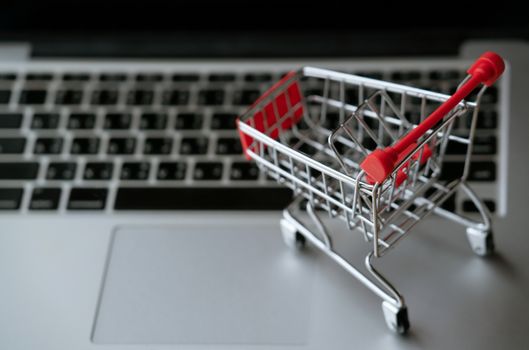 shopping cart on laptop, online shopping concept