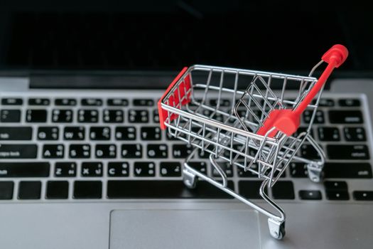 shopping cart on laptop, online shopping concept