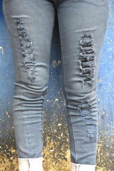 black faded jeans on concrete wall
