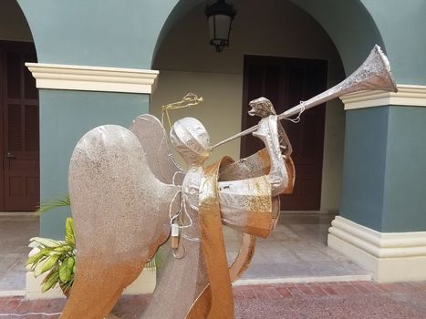 angel blowing a trumpet in Ponce, Puerto Rico and blue walls