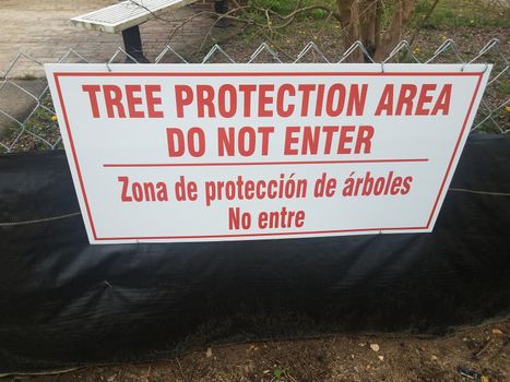 red and white tree protection area do not enter sign on fence