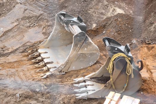 Shovels from an excavator on a construction site