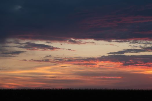 Romantic sunset with black silhouette in the foreground