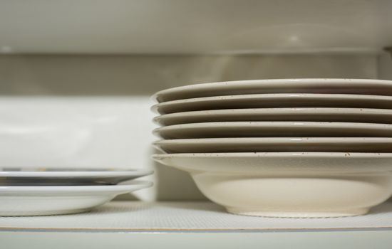 Stacked plates in the kitchen cupboard