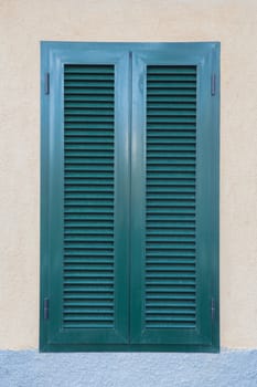 A closed shutters, painted with green paint