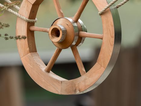 A wooden wheel hangs out as a decoration