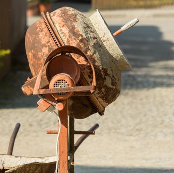 Construction site work with concrete mixer and wheelbarrows