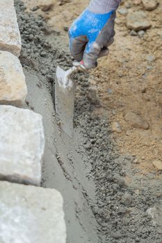 Construction site work with concrete mixer and wheelbarrows