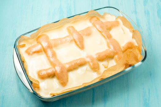 Freshly made homemade apple pie with cream of sour cream and sugar in a rectangular baking pan - photo, image.