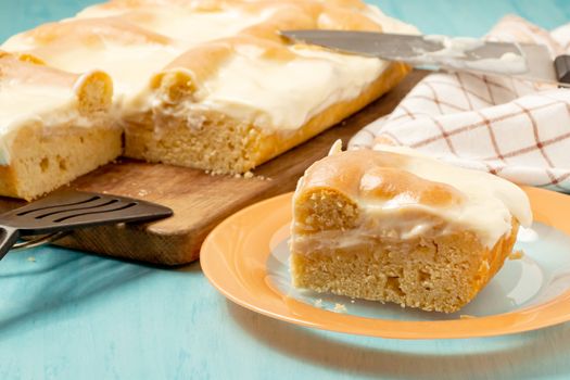 Sliced piece of apple pie with sour cream on a plate - photo, image.