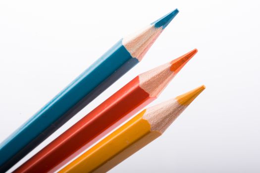 Three Color Pencils on a white background