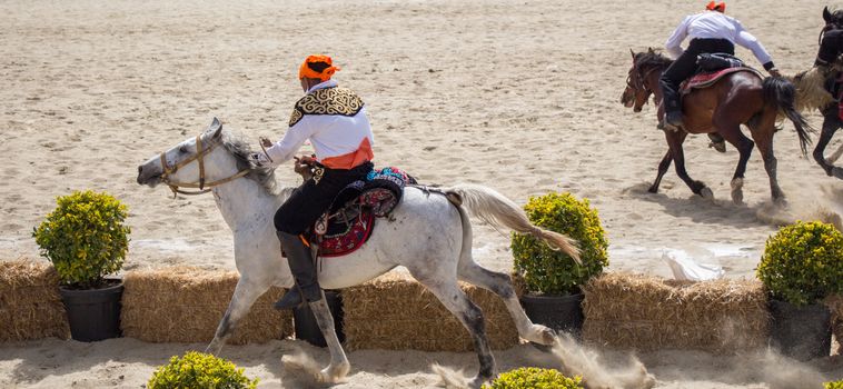 Horseman riding in their ethnic clothes on horseback