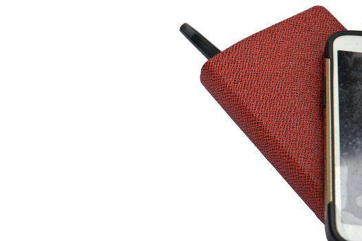 red book with ballpoint and smartphone