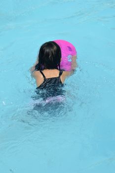 asian little girl playing in the pool