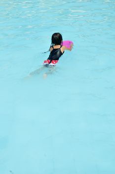 asian little girl playing in the pool