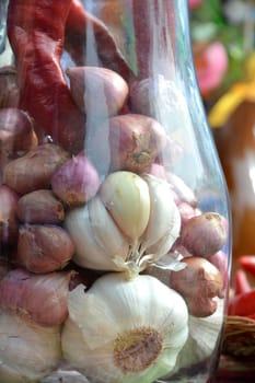 garlicand red onion on the glass jar
