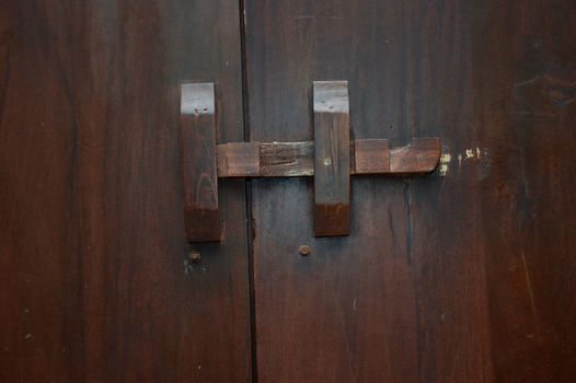 wooden lock bar on the wooden door