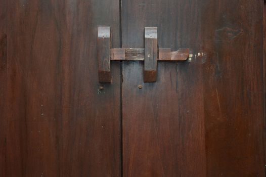 wooden lock bar on the wooden door