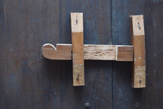 wooden lock bar on the wooden door