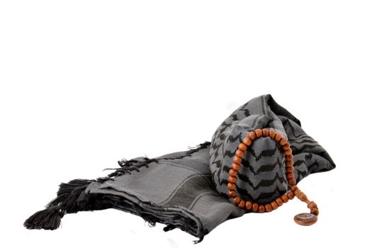 black turban and brown rosary on white background