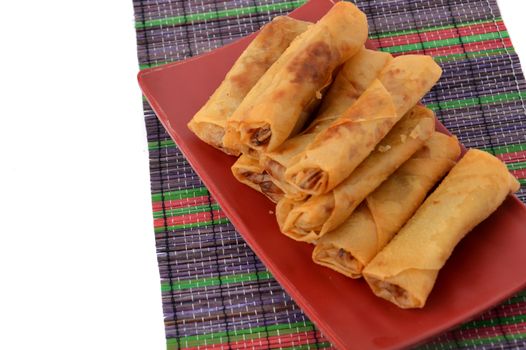 lumpia Semarang or Spring Rolls containing bamboo shoots and chicken on red plate at white background 