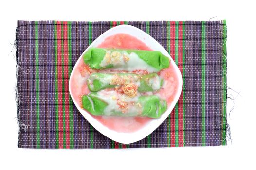 pisang ijo ice or green banana ice a tradisonal snack foods from ethnic Bugis or Makassar made of ripe banana pancakes wrapped in pandan leaf extract gravy with fla, syrup,milk and peanut powder