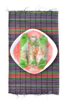 pisang ijo ice or green banana ice a tradisonal snack foods from ethnic Bugis or Makassar made of ripe banana pancakes wrapped in pandan leaf extract gravy with fla, syrup,milk and peanut powder