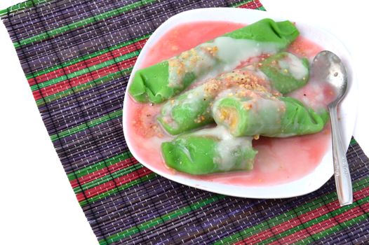 pisang ijo ice or green banana ice a tradisonal snack foods from ethnic Bugis or Makassar made of ripe banana pancakes wrapped in pandan leaf extract gravy with fla, syrup,milk and peanut powder