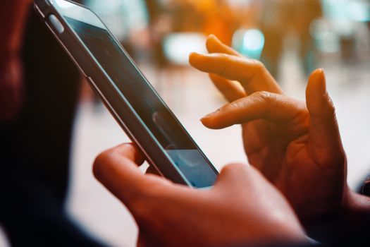 Closeup image of woman's hands holding and touching a smartphone