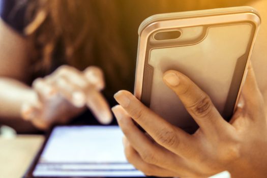 Closeup image of woman's hands holding and touching a smartphone