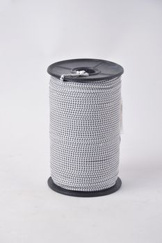 black and white spools of thread on white background