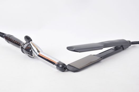 hair straightening tool and iron curly on white background