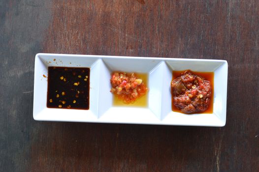 three types of chili sauce in white bowl