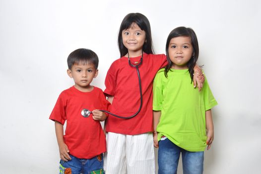 three asian kids a stethoscope