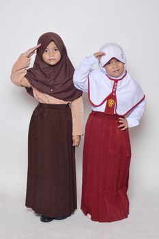 two asian little girl with primary school uniform and girl scout uniform