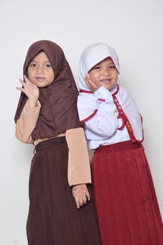 two asian little girl with primary school uniform and girl scout uniform