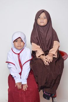 two asian little girl with primary school uniform and girl scout uniform