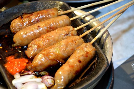 row of satay on the hot plate