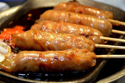 row of satay on the hot plate