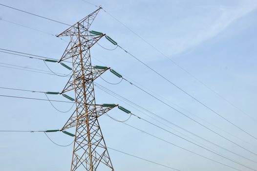 electricity poles against blue sky