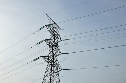 electricity poles against blue sky